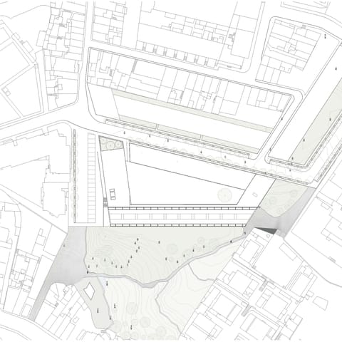 Site plan of the student residence and cultural building within the surrounding city blocks and terrain.